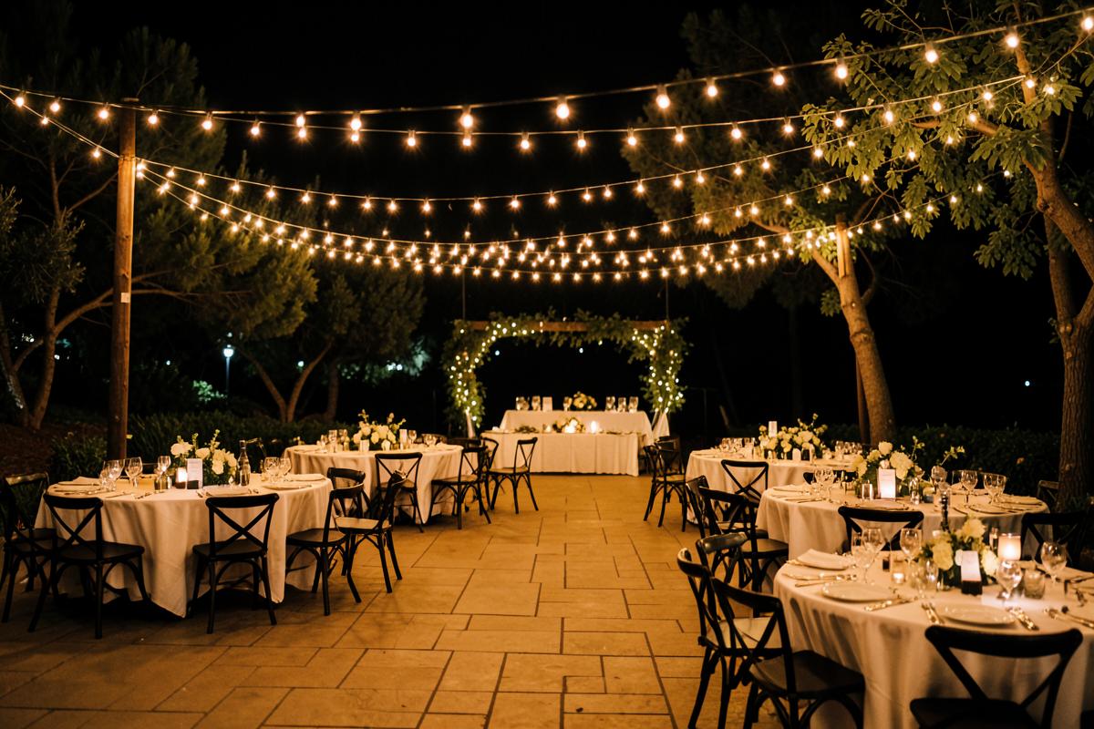 Bistro string lighting installed over an outdoor reception